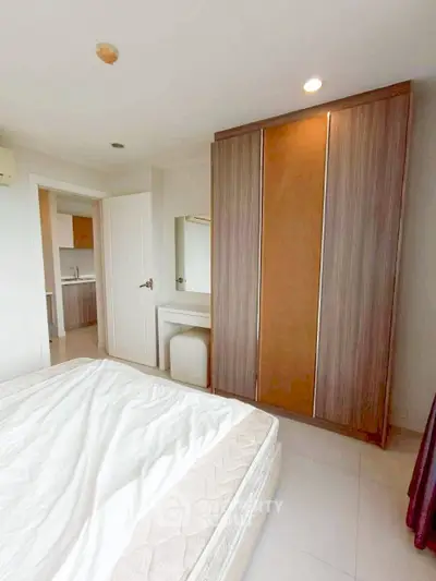 Spacious bedroom with modern wardrobe and cozy ambiance in a stylish apartment.