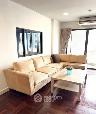 Spacious living room with cozy beige sofa and modern decor
