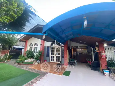 Charming suburban home with spacious covered patio and lush garden, perfect for family gatherings.