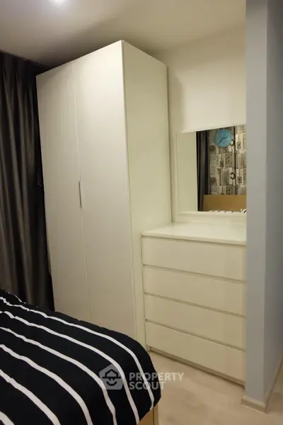 Cozy bedroom with modern wardrobe and stylish decor