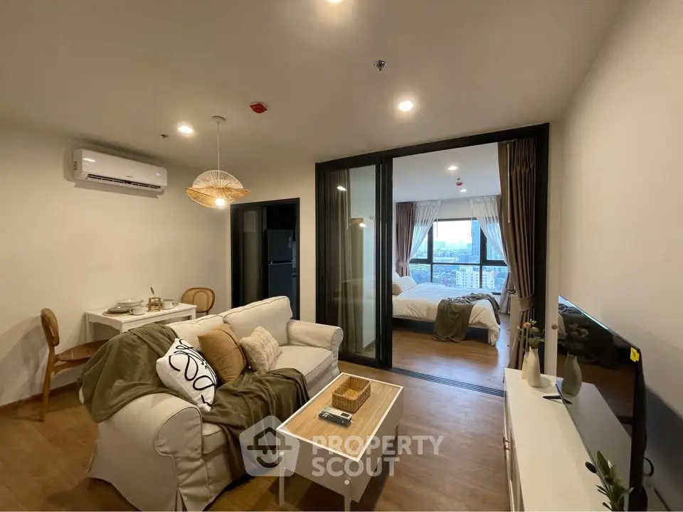 Modern open-plan living room with cozy decor and city view