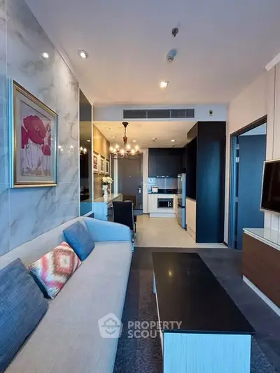 Modern living room with open kitchen and elegant decor in a stylish apartment.