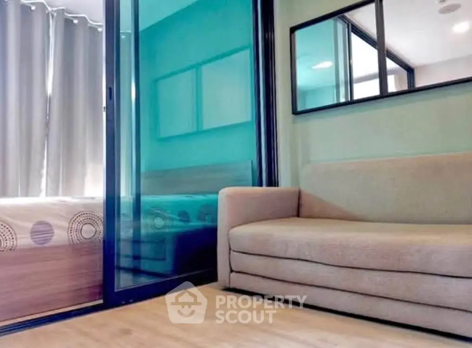 Modern living room with glass partition and cozy sofa in stylish apartment.