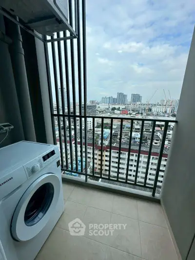 High-rise balcony with washing machine and stunning cityscape view.
