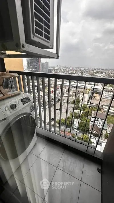 High-rise balcony with city view and washing machine, perfect for urban living.