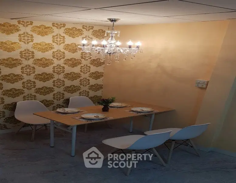 Elegant dining area with modern chandelier and stylish wallpaper