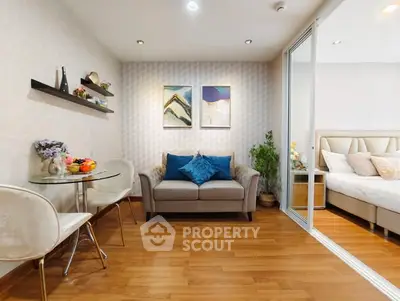 Chic modern living room with cozy seating and stylish decor adjacent to a serene bedroom.