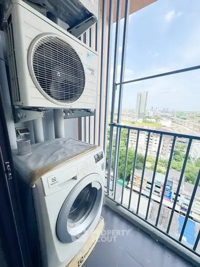 High-rise balcony with washing machine and city view, perfect for urban living.
