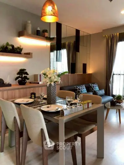 Modern dining and living area with stylish decor and natural light.