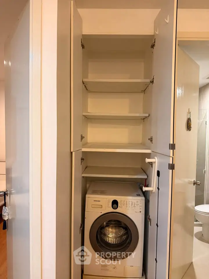 Compact laundry area with washing machine in modern apartment