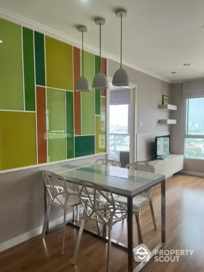 Modern dining area with vibrant wall panels and city view