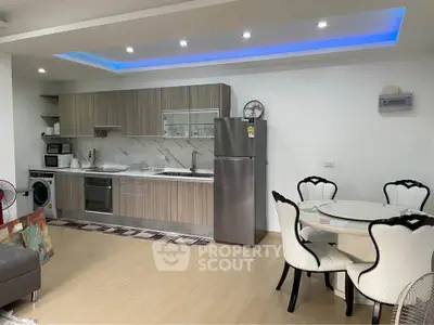 Modern open kitchen with sleek cabinetry and dining area in stylish apartment