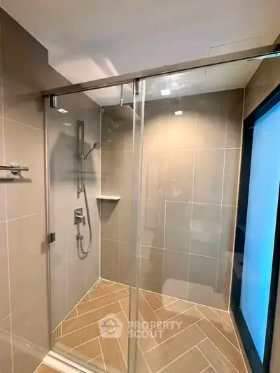 Modern bathroom with glass shower enclosure and sleek tile design