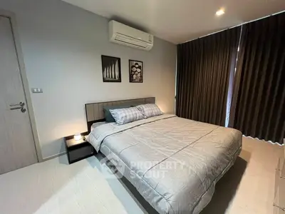 Modern bedroom with stylish decor and air conditioning in a cozy apartment.
