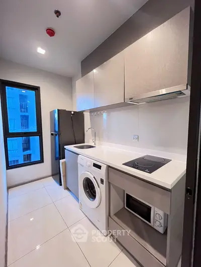 Modern kitchen with sleek appliances and ample storage space