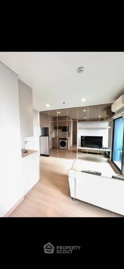 Modern living room with sleek design and large windows in a stylish apartment.
