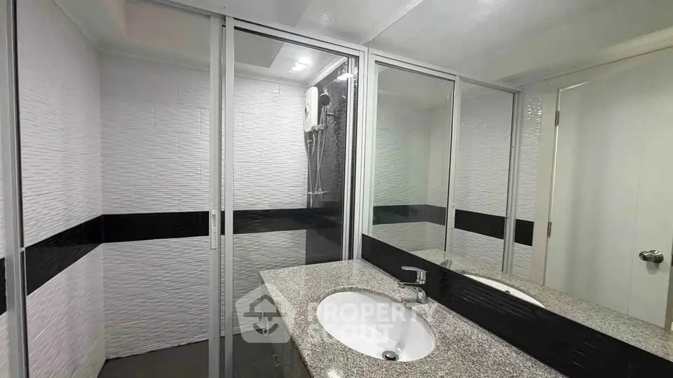 Modern bathroom with sleek design and glass shower enclosure