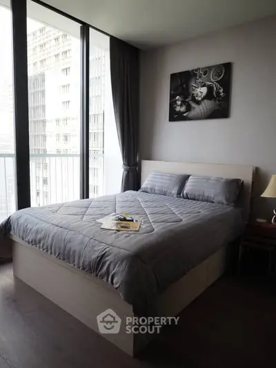 Modern bedroom with large window and stylish decor in urban apartment