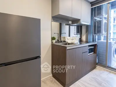 Modern kitchen with sleek cabinetry and integrated appliances in a stylish apartment.