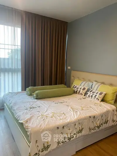 Cozy bedroom with elegant decor and natural light, featuring a comfortable bed and stylish curtains.