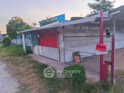 Charming small property with gated entrance and lush greenery, perfect for a cozy home or business opportunity.
