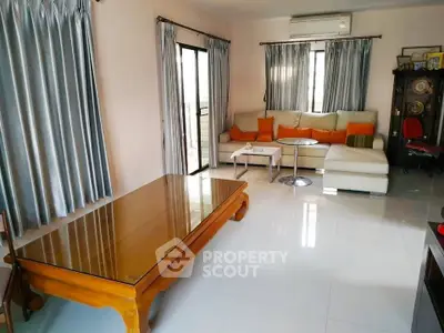 Spacious living room with modern furniture and large windows for natural light.