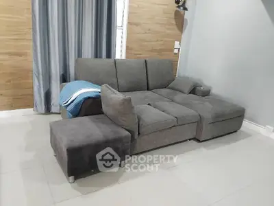 Modern living room with stylish gray sectional sofa and elegant decor