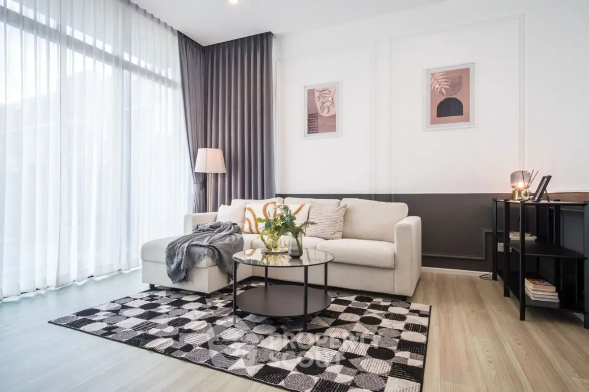 Modern living room with stylish decor and large windows