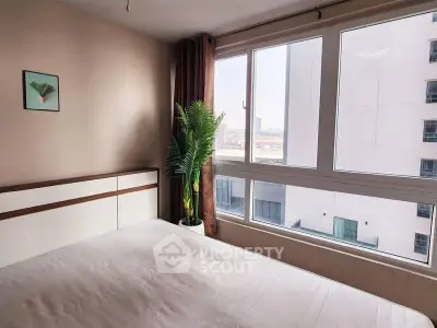 Bright bedroom with large window and modern decor in urban apartment