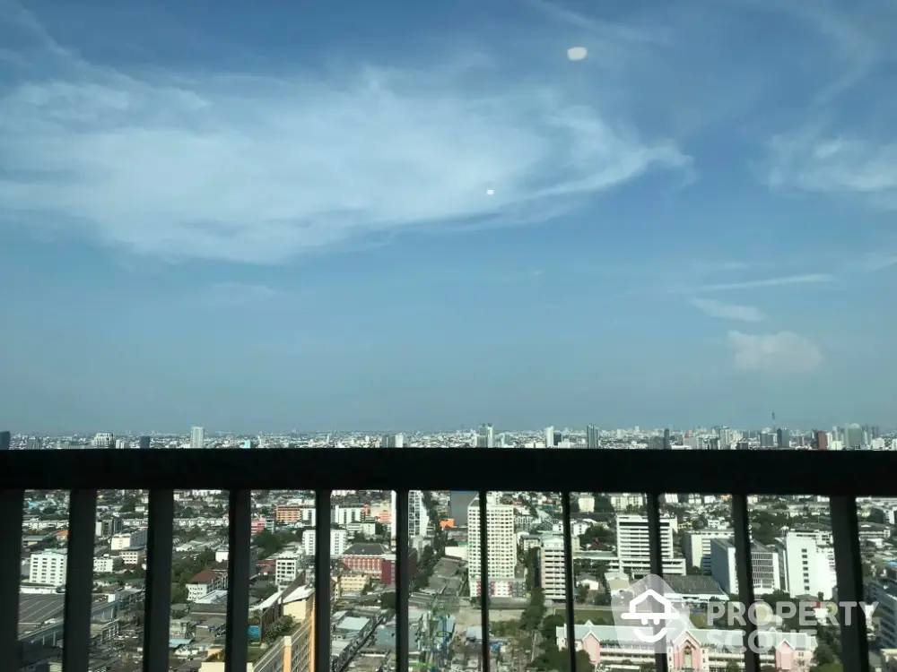 Stunning cityscape view from high-rise balcony with clear blue sky