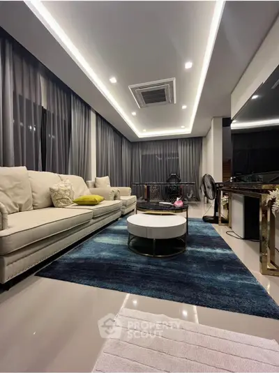 Luxurious modern living room with elegant furniture and ambient lighting, perfect for relaxation and entertainment.