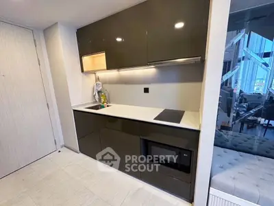 Modern compact kitchen with sleek cabinetry and built-in appliances