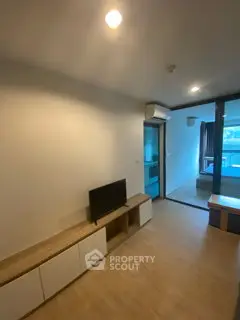 Modern living room with sleek furniture and natural light, perfect for cozy urban living.