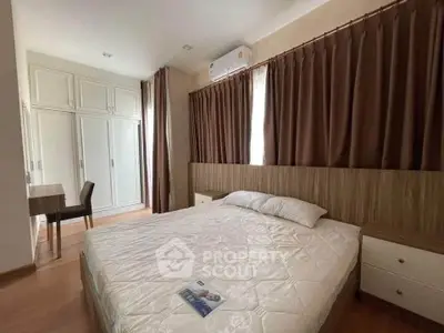 Spacious bedroom with elegant decor and ample natural light
