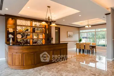 Elegant dining area with wooden bar and large windows offering garden views