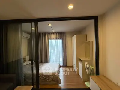 Modern bedroom with glass partition and natural light