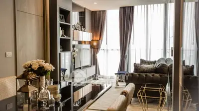 Luxurious modern living room with elegant decor and large windows offering natural light.