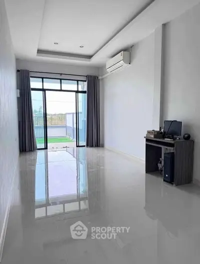 Spacious modern room with glossy floor and large window view