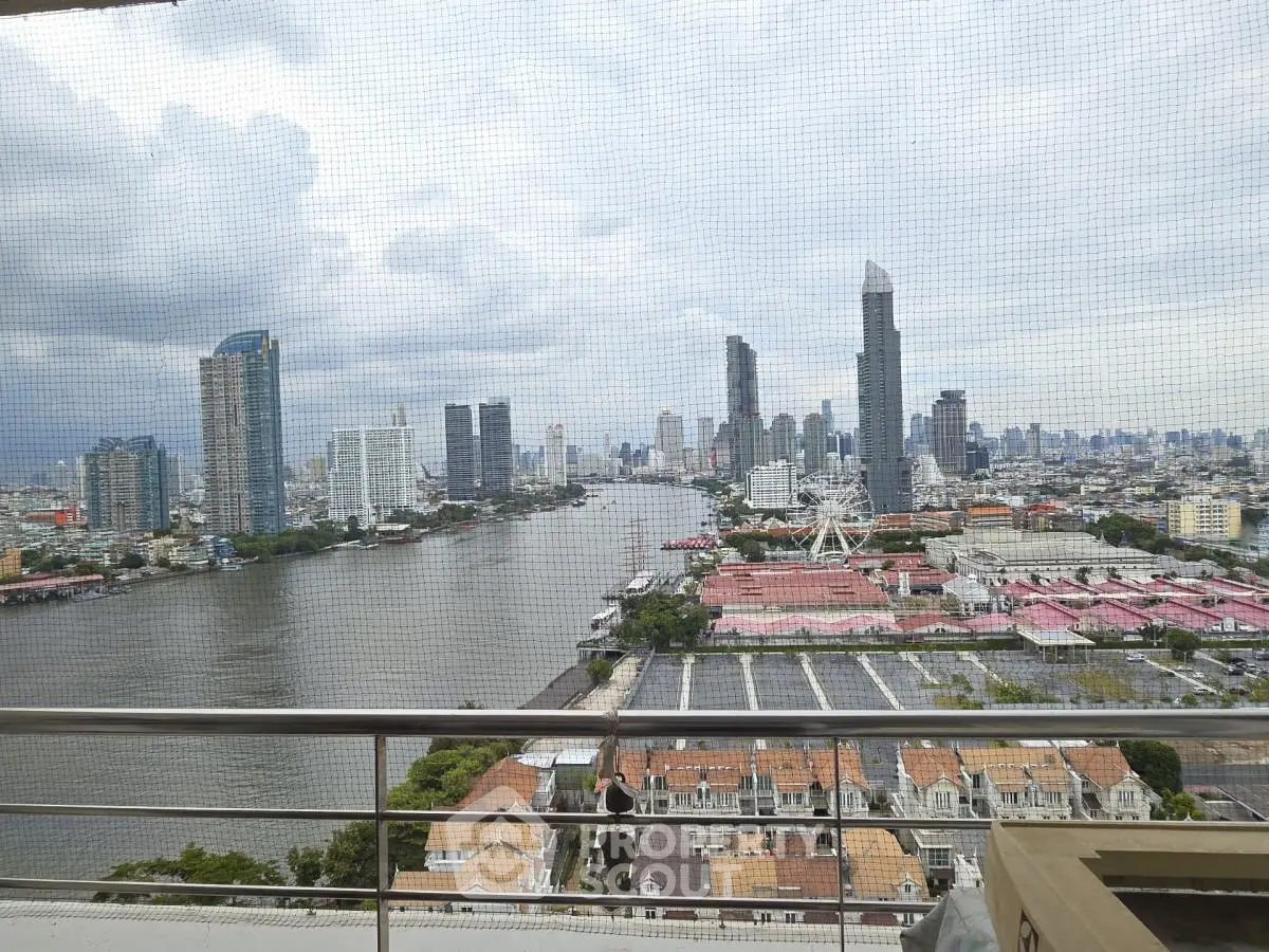 Stunning cityscape view from high-rise balcony overlooking river and skyline