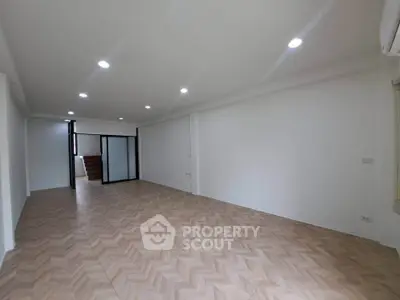 Spacious modern living room with elegant flooring and recessed lighting