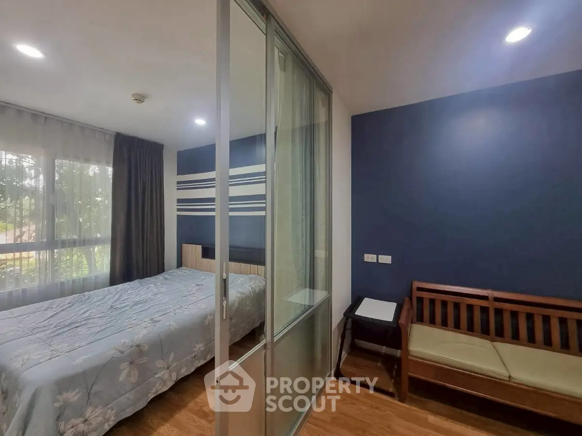 Modern bedroom with sliding glass doors and cozy seating area