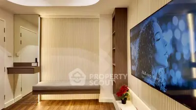 Modern living room with sleek design and large wall-mounted TV