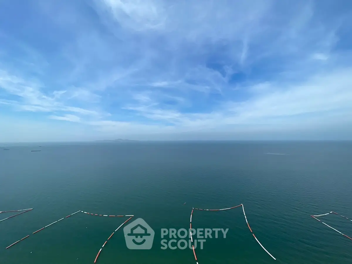 Breathtaking ocean view from a high-rise apartment, showcasing endless blue skies and serene waters.