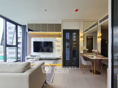 Modern living room with stylish decor and large TV in a high-rise apartment