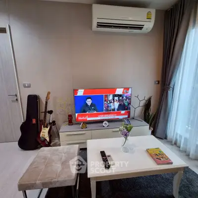 Modern living room with air conditioning, TV, and stylish decor in a cozy apartment.