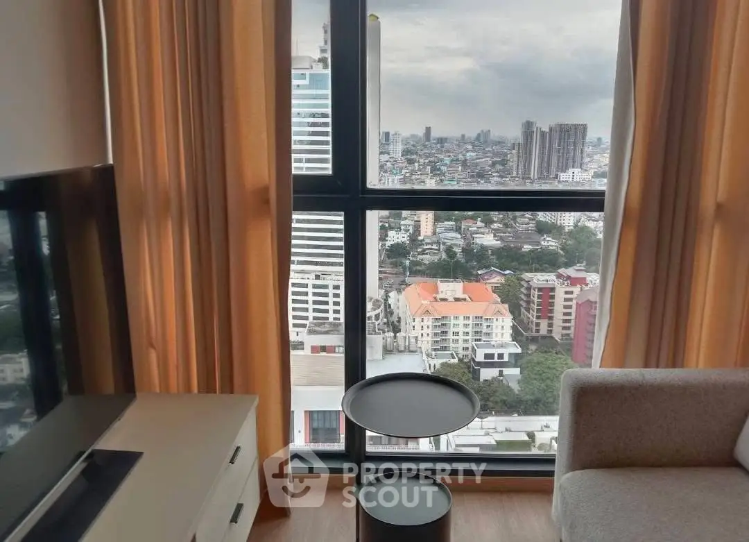 Stunning city view from modern high-rise apartment living room with floor-to-ceiling windows.