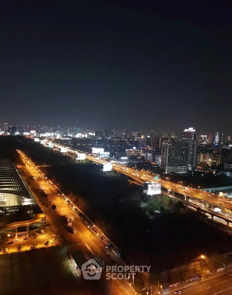 Stunning cityscape night view from high-rise building showcasing vibrant urban lights and skyline.