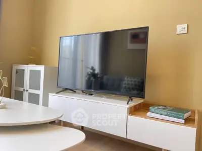 Modern living room with sleek TV setup and stylish furniture