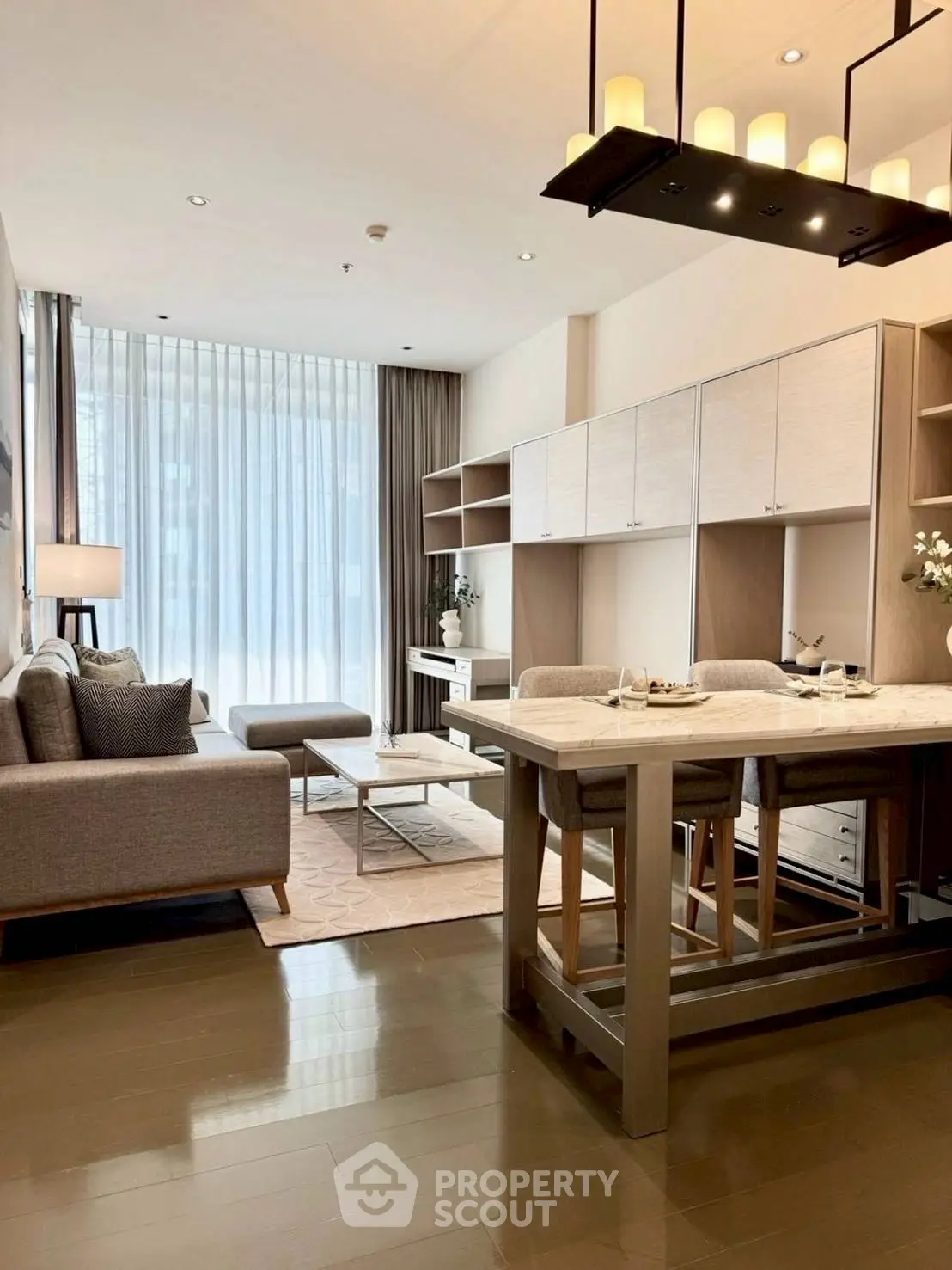 Modern open-plan living room with elegant decor and natural light