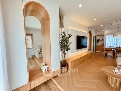 Modern living room with stylish wood accents and built-in TV unit